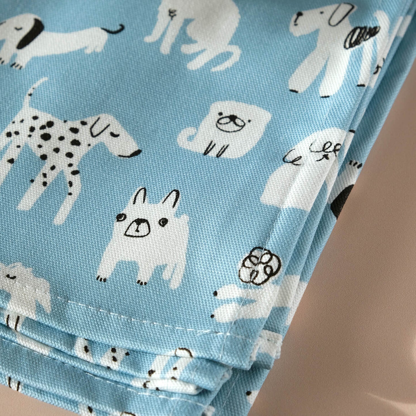 Close up of Dog Tea Towel to show a Dalmatian and french bulldog on a blue background - The Moonlit Press UK