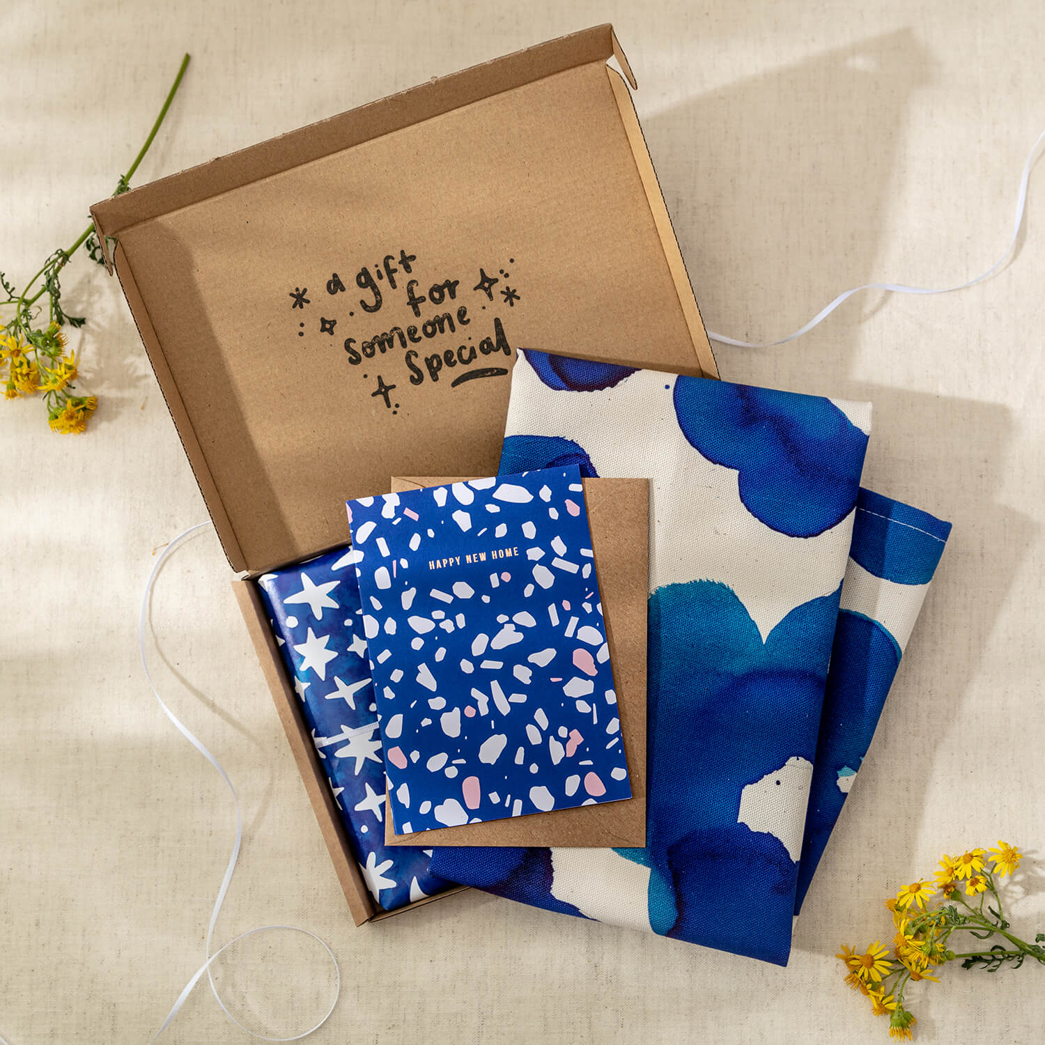Happy New Home Letterbox Gift includes one cotton tea towel and a handwritten 'Happy New Home' greeting card - The Moonlit Press