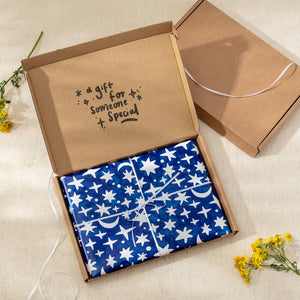 Housewarming Gift in Celestial Gift Wrap and White Ribbon inside a letterbox sized box
