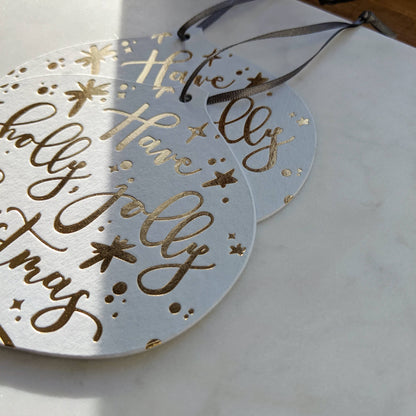 Christmas Card Decoration with gold letterpress stars and 'Have a holly, jolly Christmas' message